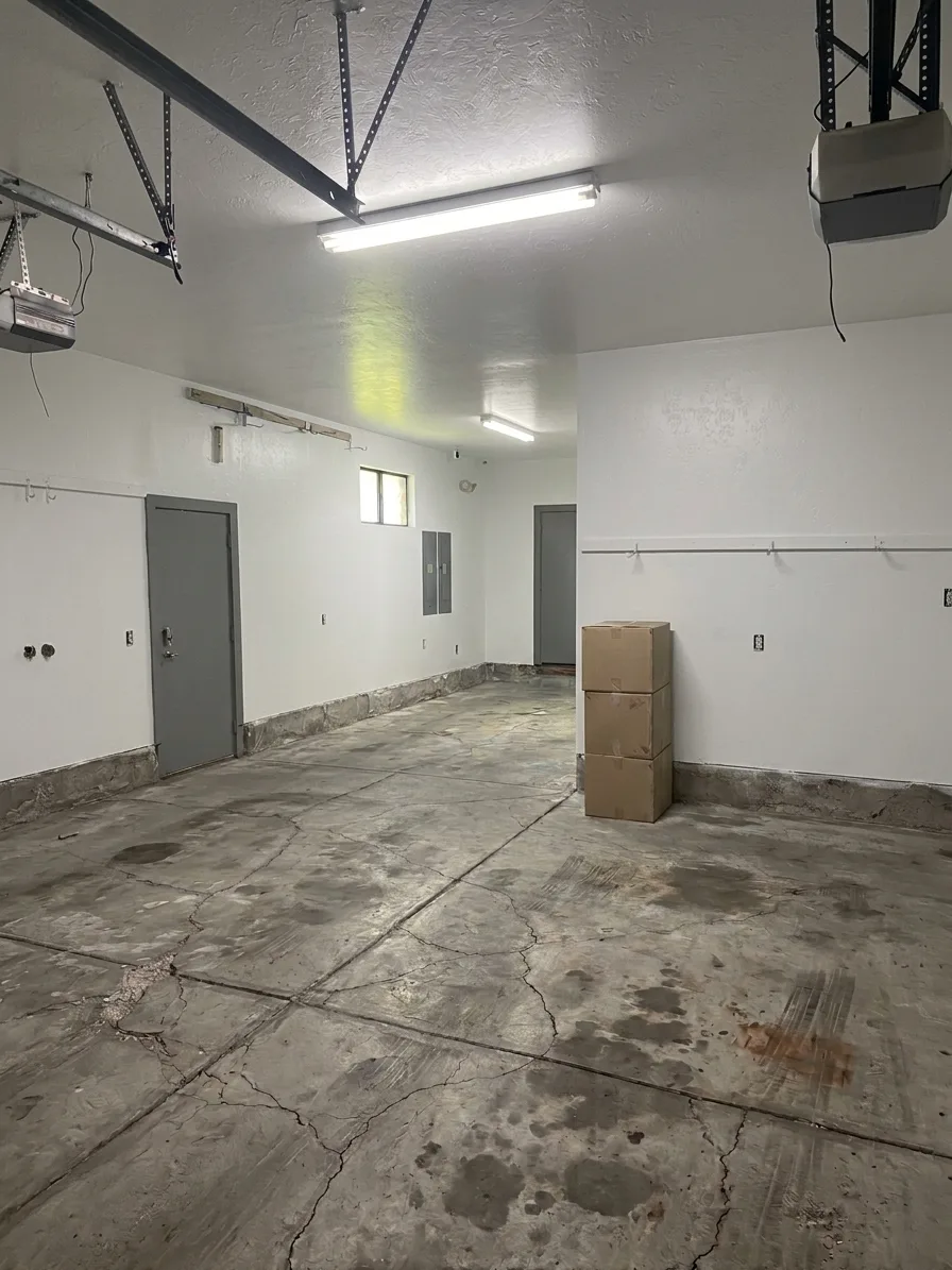 Bare, stained garage concrete floor before coating